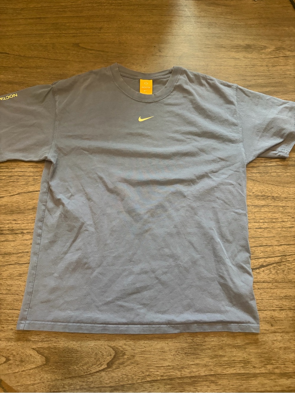 Nocta Nike Men’s Grey/Blue T-Shirt with Yellow Swoosh